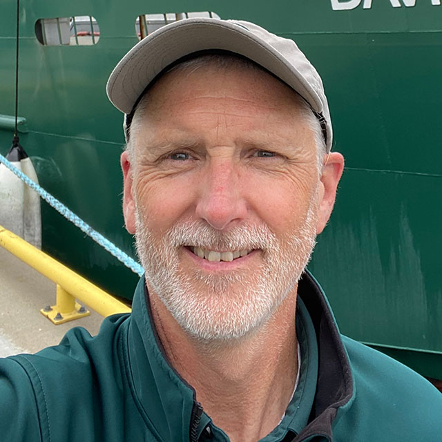 A headshot photo of Scott Parker wearing a Parks Canada uniform.