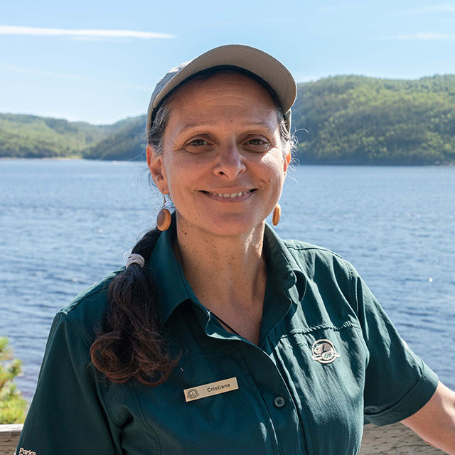 A headshot photo of Cristiane Albuquerque wearing a Parks Canada uniform.