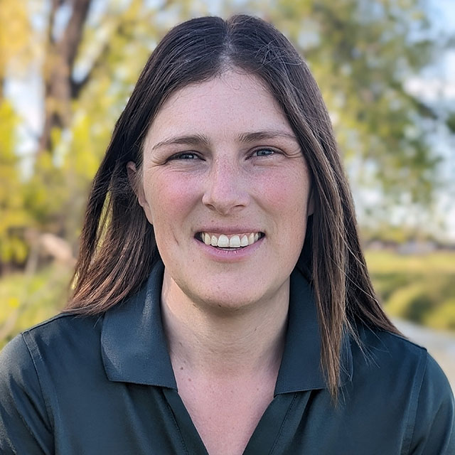 A headshot photo of Julia Put in a Parks Canada uniform.
